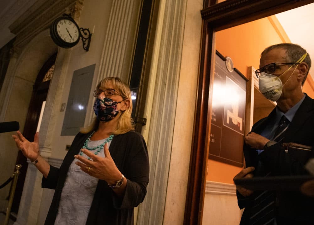 A clock on the corridor wall displayed the time -- 4:20 a.m. -- while Senate President Karen Spilka spoke to reporters outside the Senate Chamber early Tuesday morning, alongside Sen. William Brownsberger, after the branch passed a wide-ranging police reform bill during a marathon 16-hour session. (Sam Doran/SHNS)