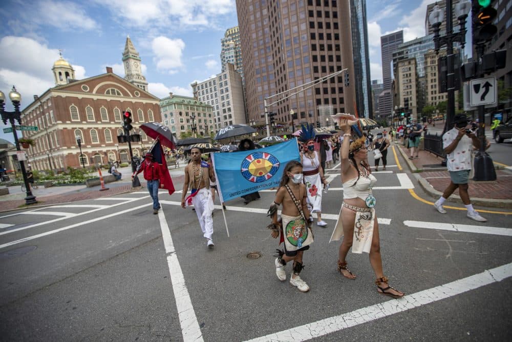 Protesters leave the plaza of Faneuil Hall to march down Congress Street toward Boston City Hall. (Jesse Costa/WBUR)