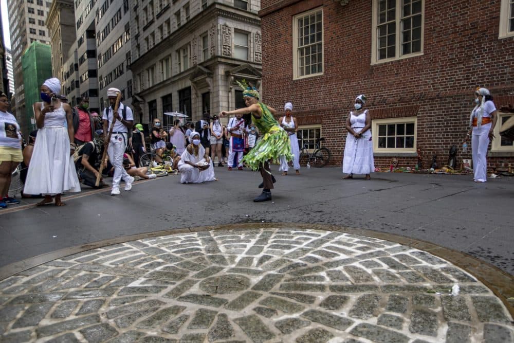 Protesters stop at the site of the Boston Massacre to hold a celebration of Indigenous song and dance. (Jesse Costa/WBUR)