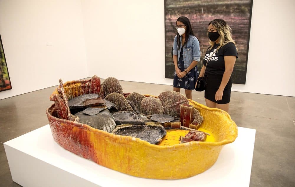 Midaly Carrsaquillo and Chanthy Ngin look at a basin from Sterling Ruby's "Basin Theology" at the ICA. (Robin Lubbock/WBUR)
