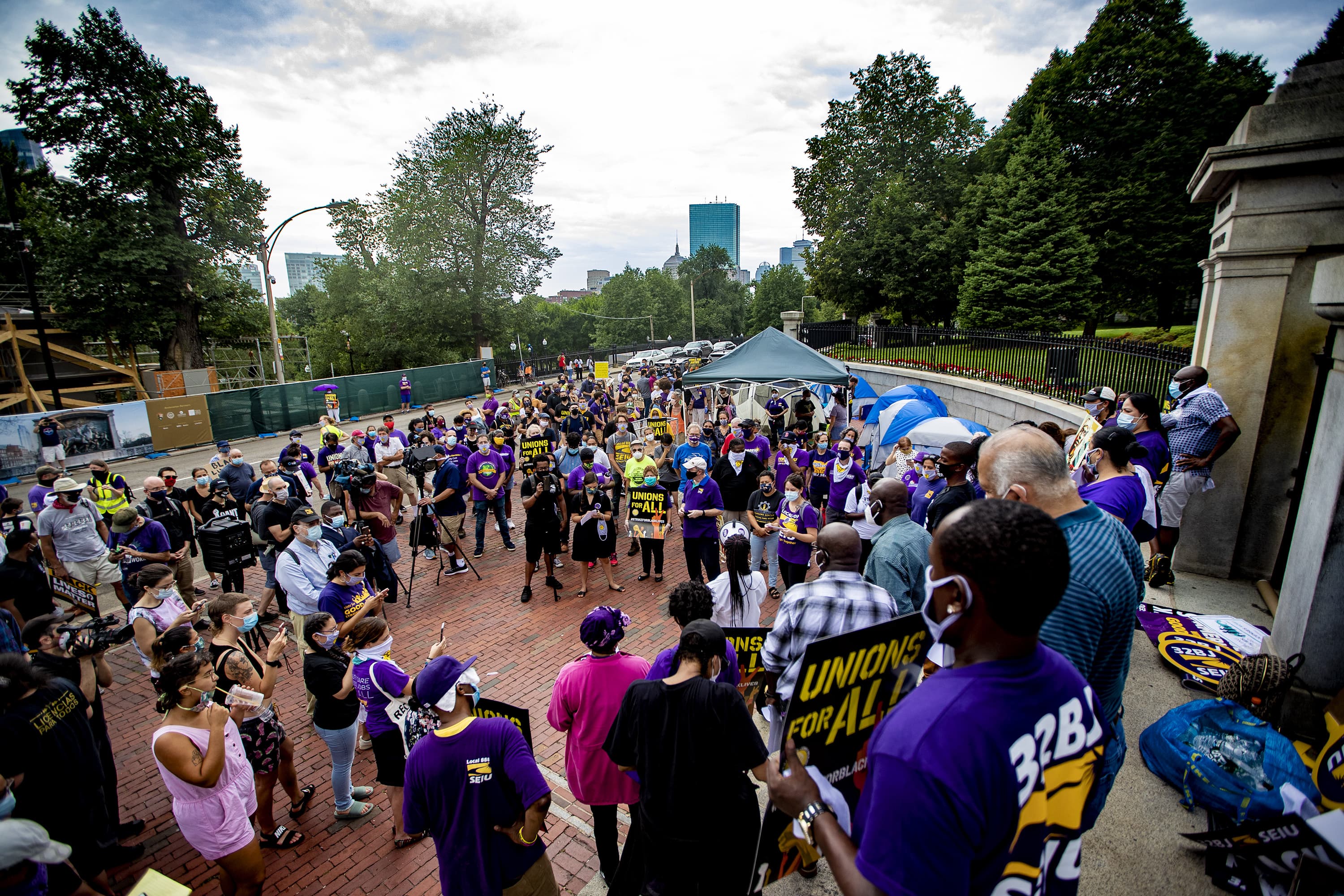People gather on the State House steps in Boston for the Strike for Black Lives on Monday morning. (Jesse Costa/WBUR)