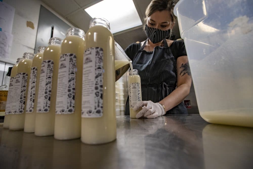 McMahan fills each bottle with piña colada. (Jesse Costa/WBUR)