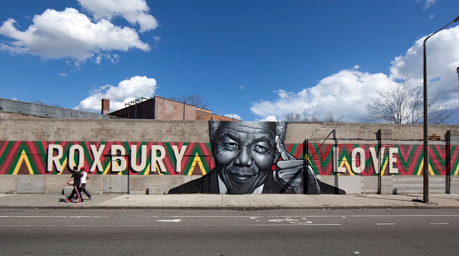 The “Roxbury Love” mural on Warren Street in Roxbury before its demolition. (Joe Difazio for WBUR)