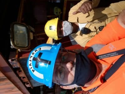 Rev. Steve Cushing and a seafarer meet on a gangplank at the Conley Container Terminal in South Boston. (Courtesy New England Seafarers Mission)