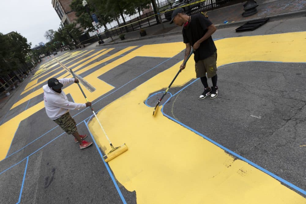 Lee Beard, left, and Paul "Mars" Chapman paint the phrase "Black Lives Matter" on Washington Street, July 5. (AP Photo/Michael Dwyer)