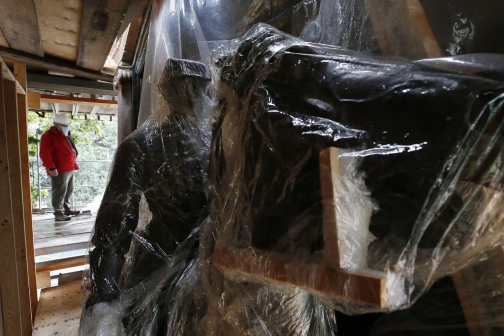 Protective plastic covers the bronze bas-relief of the Shaw 54th Regiment memorial during the restoration process, July 17, 2020, in Boston. (Michael Dwyer/AP)