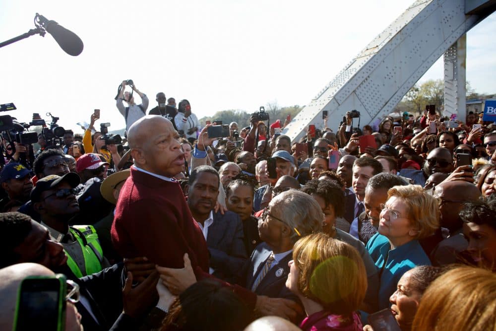 Former South Bend Mayor Pete Buttigieg (3r top), Reverend Al Sharpton, and Sen. Elizabeth Warren (D-MA) (R) listen to Rep. John Lewis (D-AL) speak as they march during the Annual Bloody Sunday March across the Edmund Pettus Bridge in Selma, Alabama on March 1, 2020. (Joshua Lott/AFP/Getty Images)