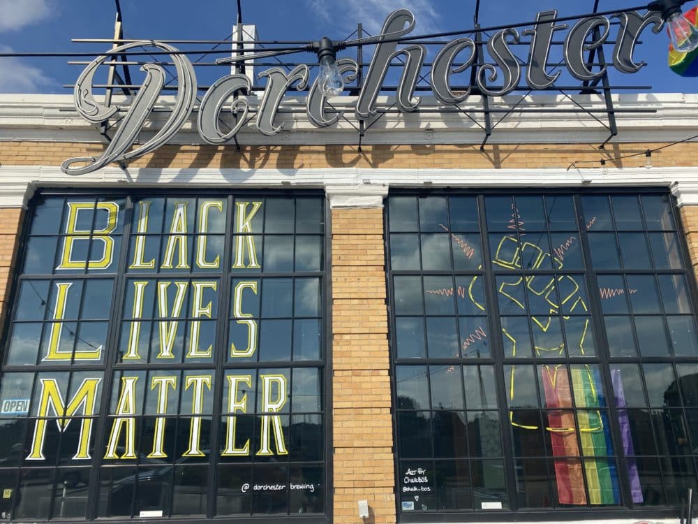 A Black Lives Matter sign and fist are pictured on the Dorchester Brewing Company storefront windows. (Courtesy Dorchester Brewing Company)