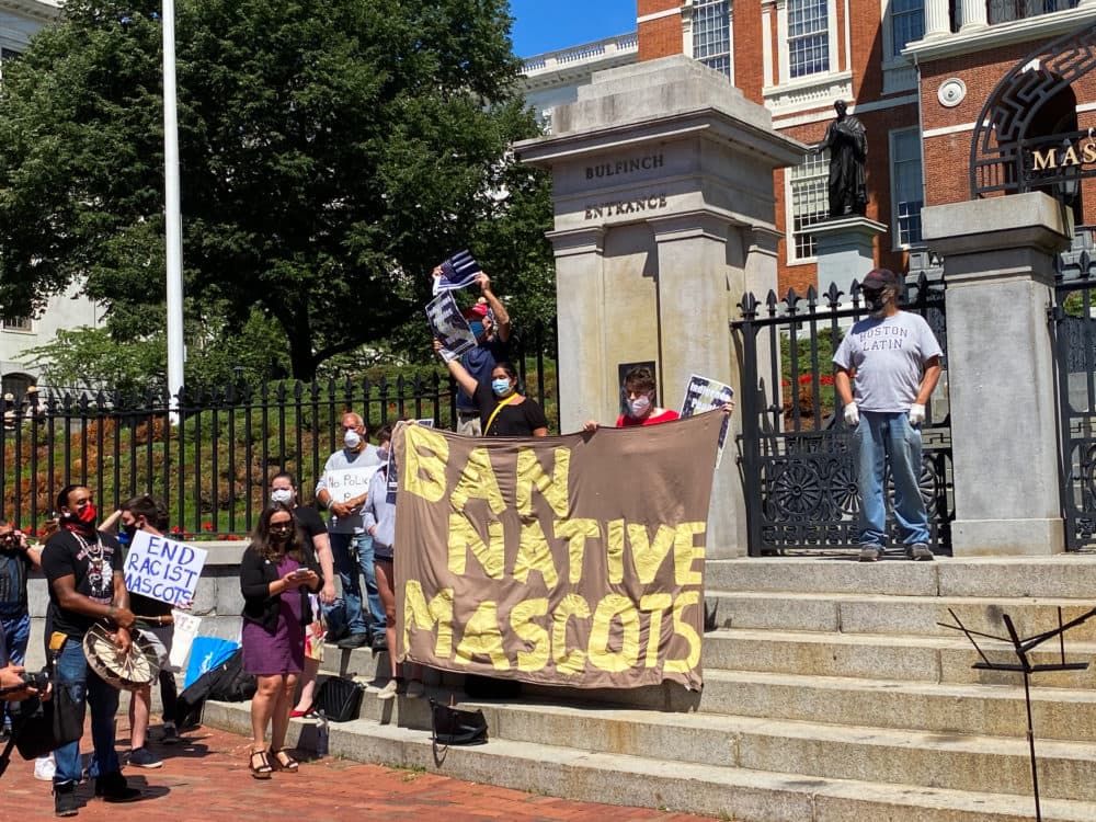 A group of Indigenous people, advocates, and lawmakers gathered outside the State House Thursday calling on the Legislature to redesign the state's flag and motto. (Chris Van Buskirk/SHNS)