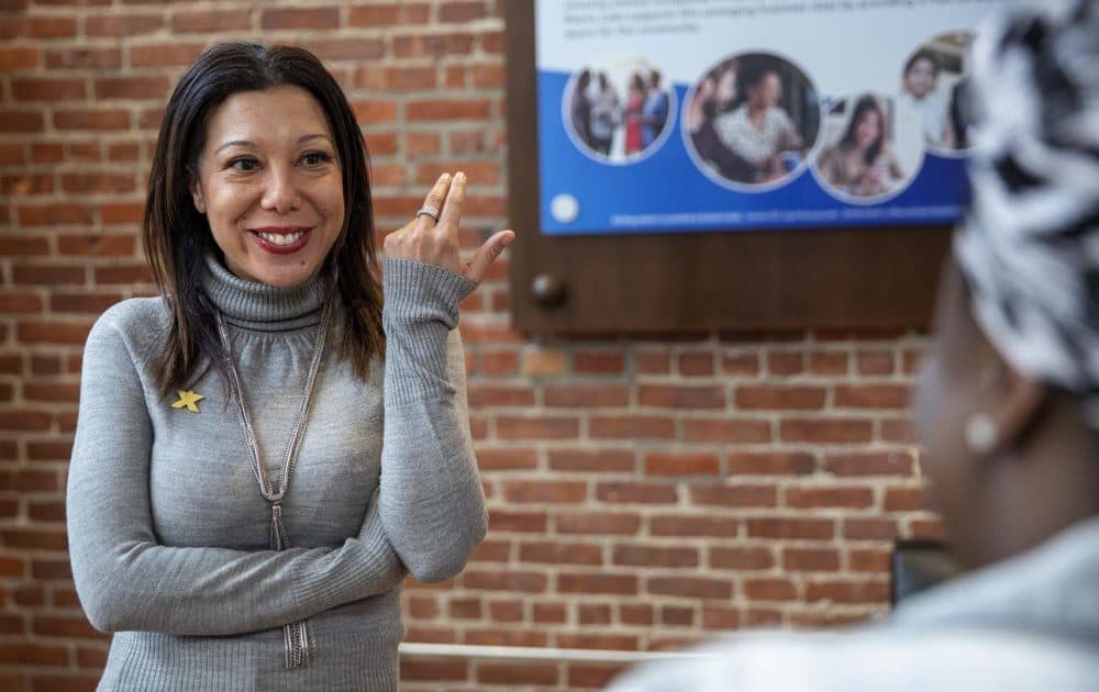Malia Lazu talks with a visitor at Reevx Labs coworking space in Roxbury. (Robin Lubbock/WBUR)