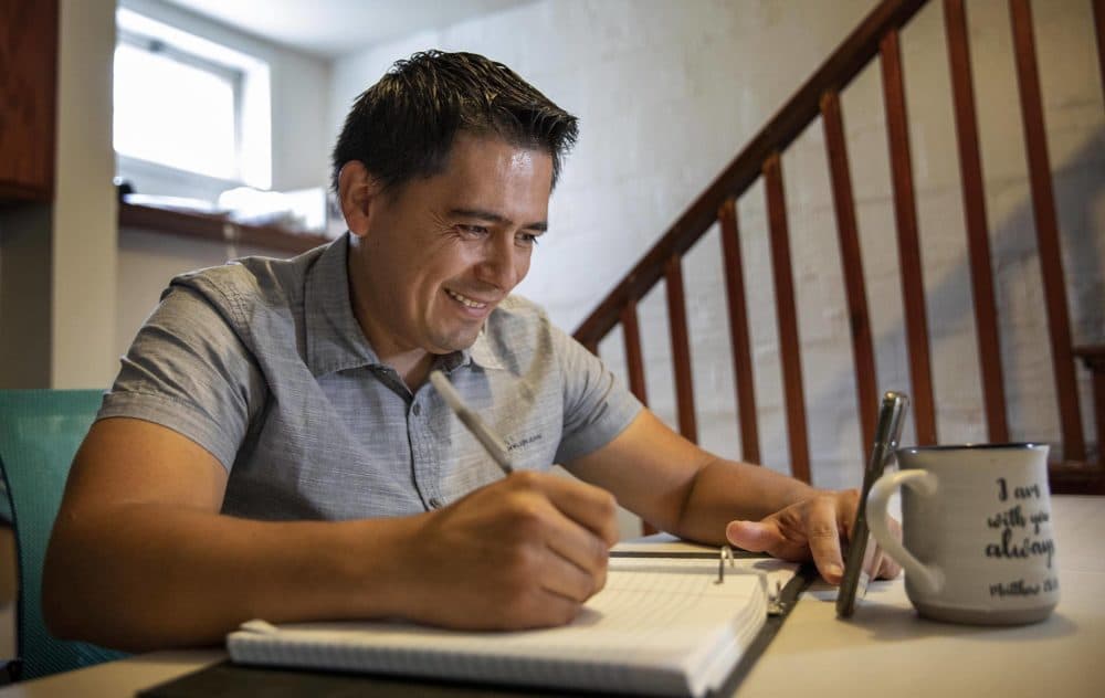 From his basement in Lynn, Edwin Rivera attends ESOL classes online. Since the COVID-19 pandemic closed down his two restaurant jobs, he has been using his time to develop his English skills with the goal of becoming a medical interpreter. (Robin Lubbock/WBUR)
