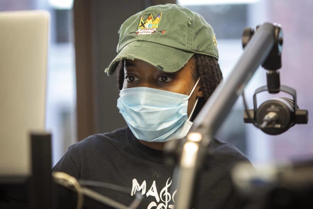 DJ WhySham, Shamara Rhodes, at work on the show she co-hosts on Spark FM Online. (Robin Lubbock/WBUR)
