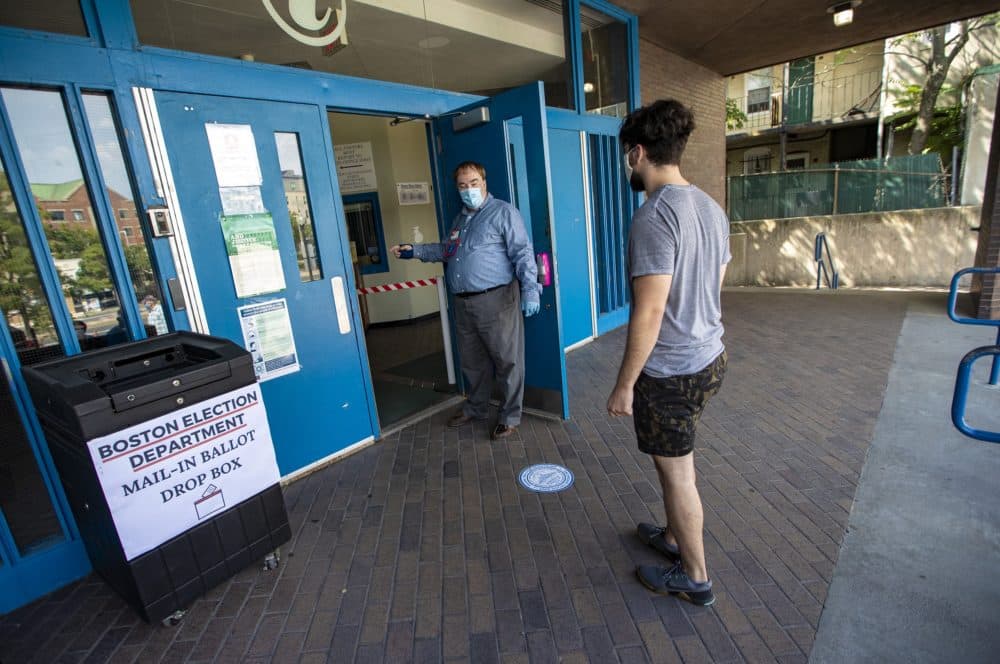 Voters are ushered in one-at-a-time at Jacskson Mann School on the first day of early voting for the Massachusetts primary. A drop box was placed by the entrance of the polling location for those opting to vote-by-mail to drop off their ballots. (Jesse Costa/WBUR)