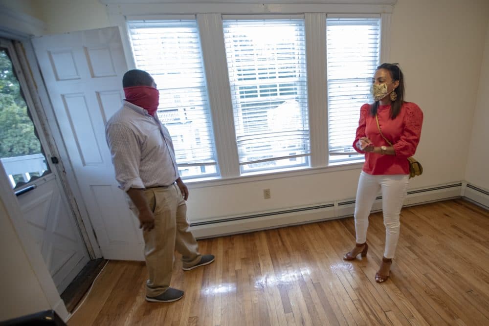 Realtor Jonathan Viciere and condominium owner Mindy Wright wait for prospective renters to show up at the open house. (Jesse Costa/WBUR)