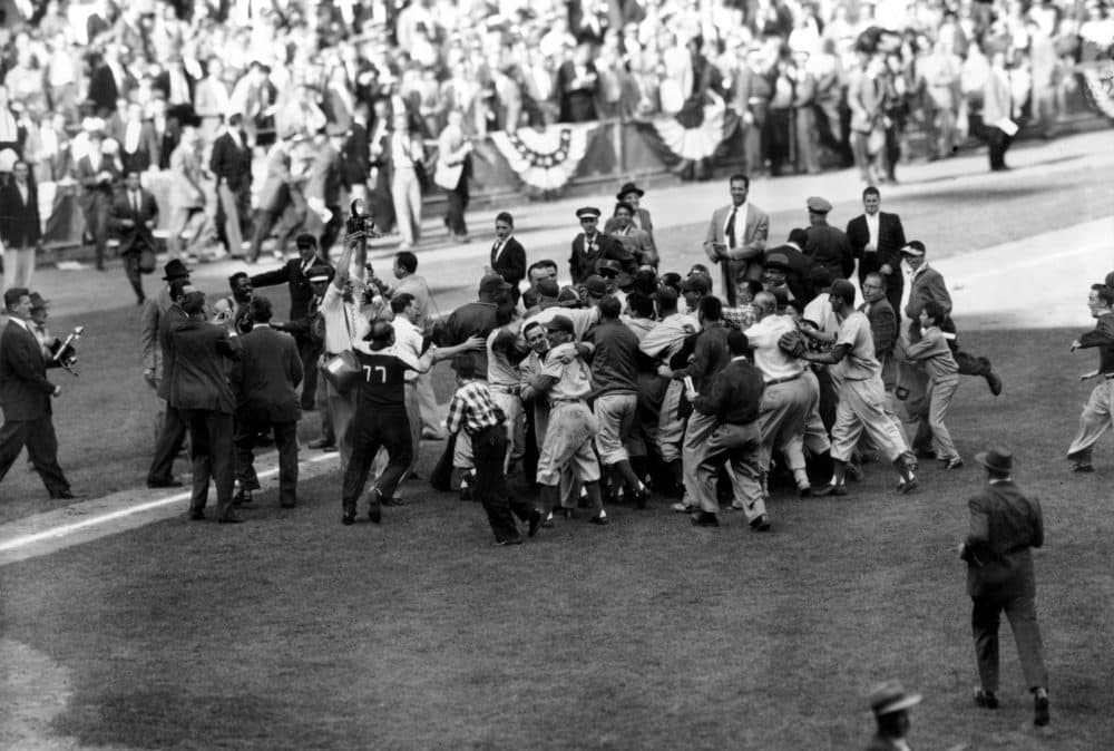 The Brooklyn Dodgers mob pitcher Johnny Podres after defeating the New York Yankees in the seventh and deciding game of the Subway Series to win the 1955 World Series. (AP)