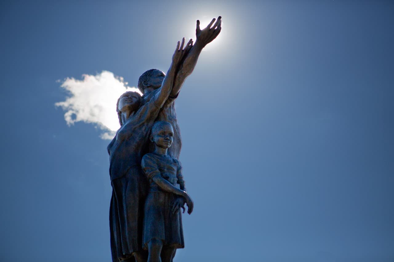 "Rise," the 19-foot bronze sculpture by former Mattapan resident Fern Cunningham-Terry, stands at the gateway to Mattapan Square on Blue Hill Avenue. (Jesse Costa/WBUR)