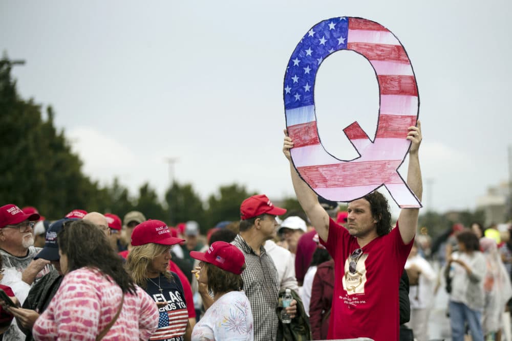 In this Aug. 2, 2018 file photo, David Reinert holding a Q sign waits in line with others to enter a campaign rally with President Donald Trump in Wilkes-Barre, Pa. (Matt Rourke, File/AP)
