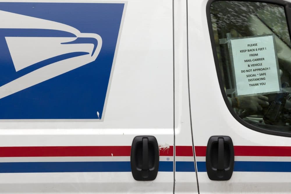 In this May 1, 2020, file photo, a sign in the window of a U.S. mail truck in Boston asks that people not approach closer than six feet due to concern about COVID-19. (Michael Dwyer/AP File)
