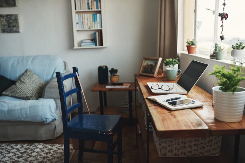 Cropped shot of technology and a notebook on a desk in an empty home office during the day. (Getty Images)