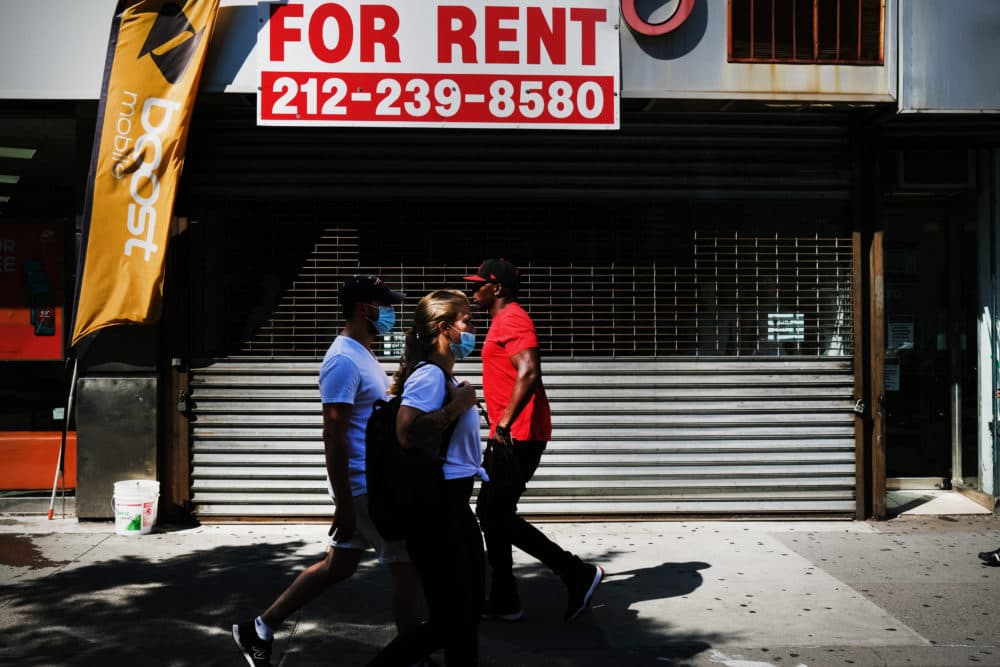 People walk by a closed business on July 21, 2020 in the Brooklyn borough of New York City. (Spencer Platt/Getty Images)