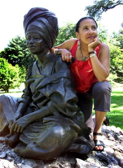 Artist Fern Cunningham-Terry of Boston with her sculpture "The Sentinal," located in Forest Hills Cemetery. (Tom Herde/The Boston Globe/Getty Images)