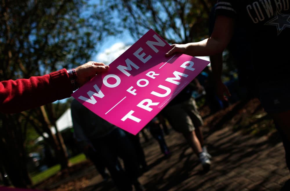Volunteers pass out "Women For Trump" signs before a campaign event featuring then Republican presidential candidate Donald Trump at Regent University Oct. 22, 2016 in Virginia Beach, Virginia. (Win McNamee/Getty Images)