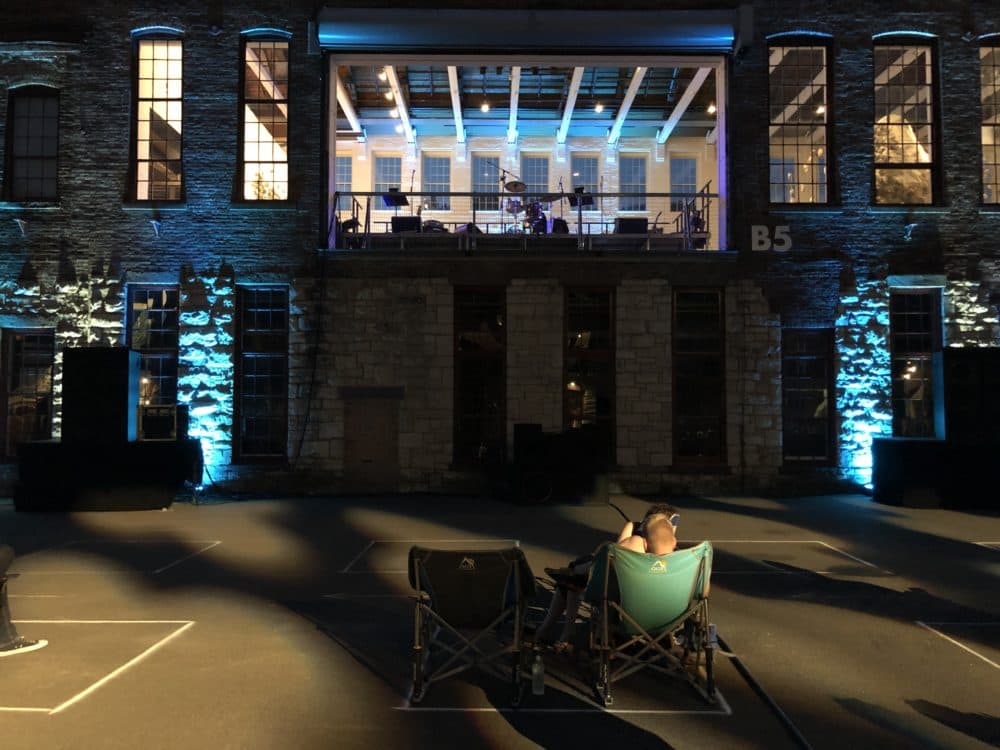 You La Tengo played above the audience in a massive doorway on the second story of an old mill building at Mass MoCA. (Andrea Shea/WBUR)