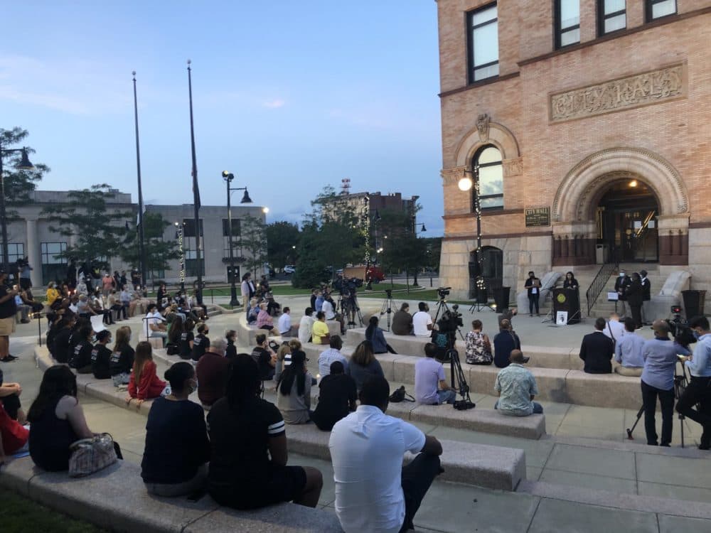 People gather to honor Sgt. Elder Fernandes in Brockton outside Brockton City Hall Friday evening. (Bruce Gellerman/WBUR)