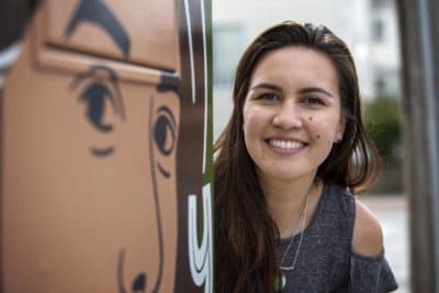 Artist Amanda Beard Garcia at her "You Belong Here" utility box on Harvard Street in South Medford. (Robin Lubbock/WBUR)