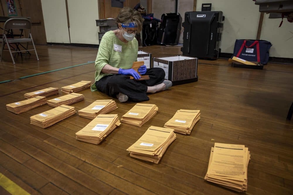 Polling inspector Ann McClenahan counts early voting ballot envelopes at the polling station on Linnaean St. in Cambridge, Mass. (Robin Lubbock/WBUR)