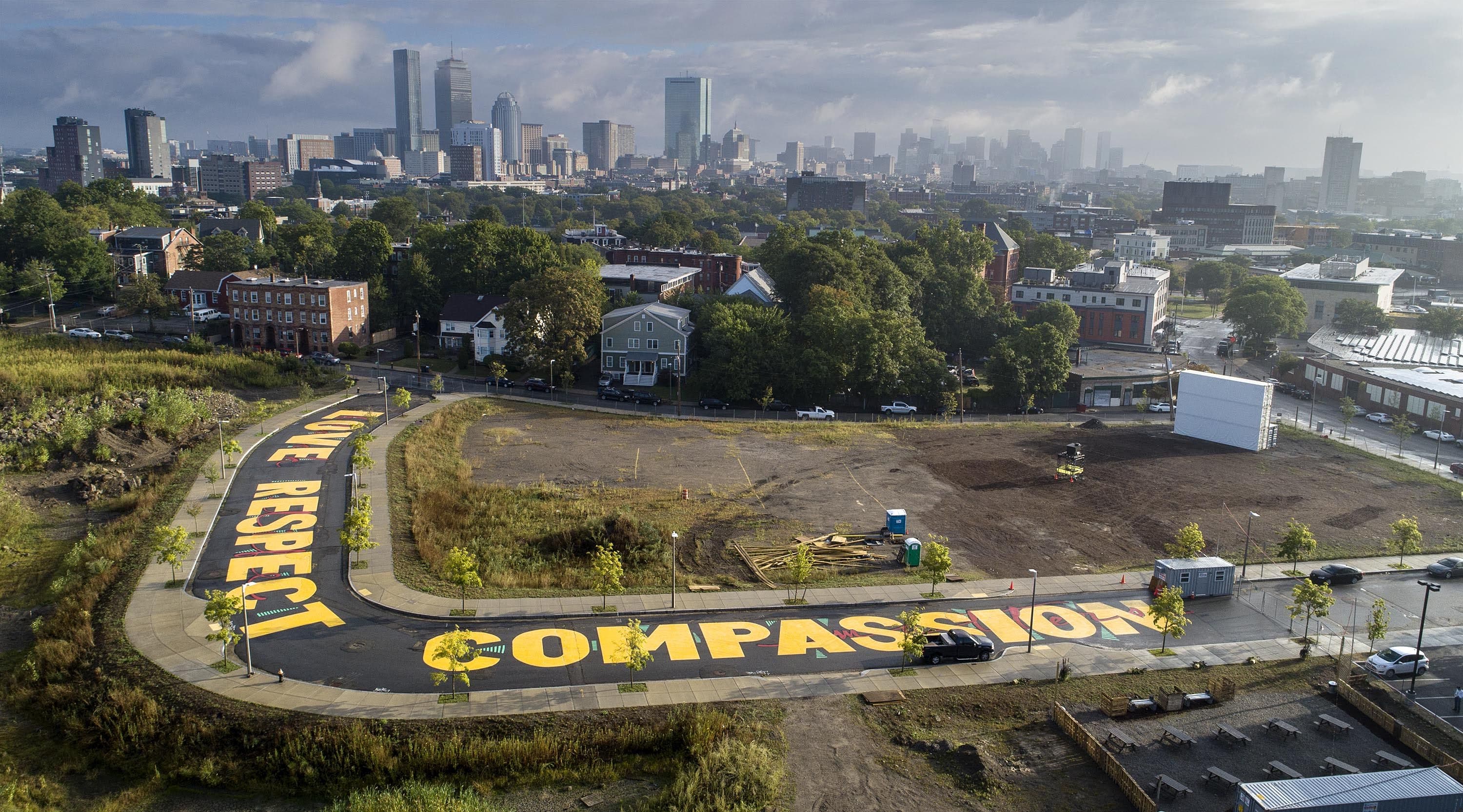 Artist Ricardo "Deme5" Gomez's street painting titled "Rules of Engagement" on Bartlett Station Drive in Roxbury, Massachusetts. (Robin Lubbock/WBUR)