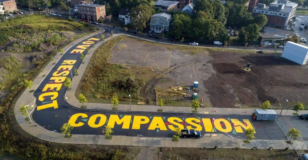 Artist Ricardo "Deme5" Gomez's street painting titled "Rules of Engagement" on Bartlett Station Drive in Roxbury, Mass. (Robin Lubbock/WBUR)