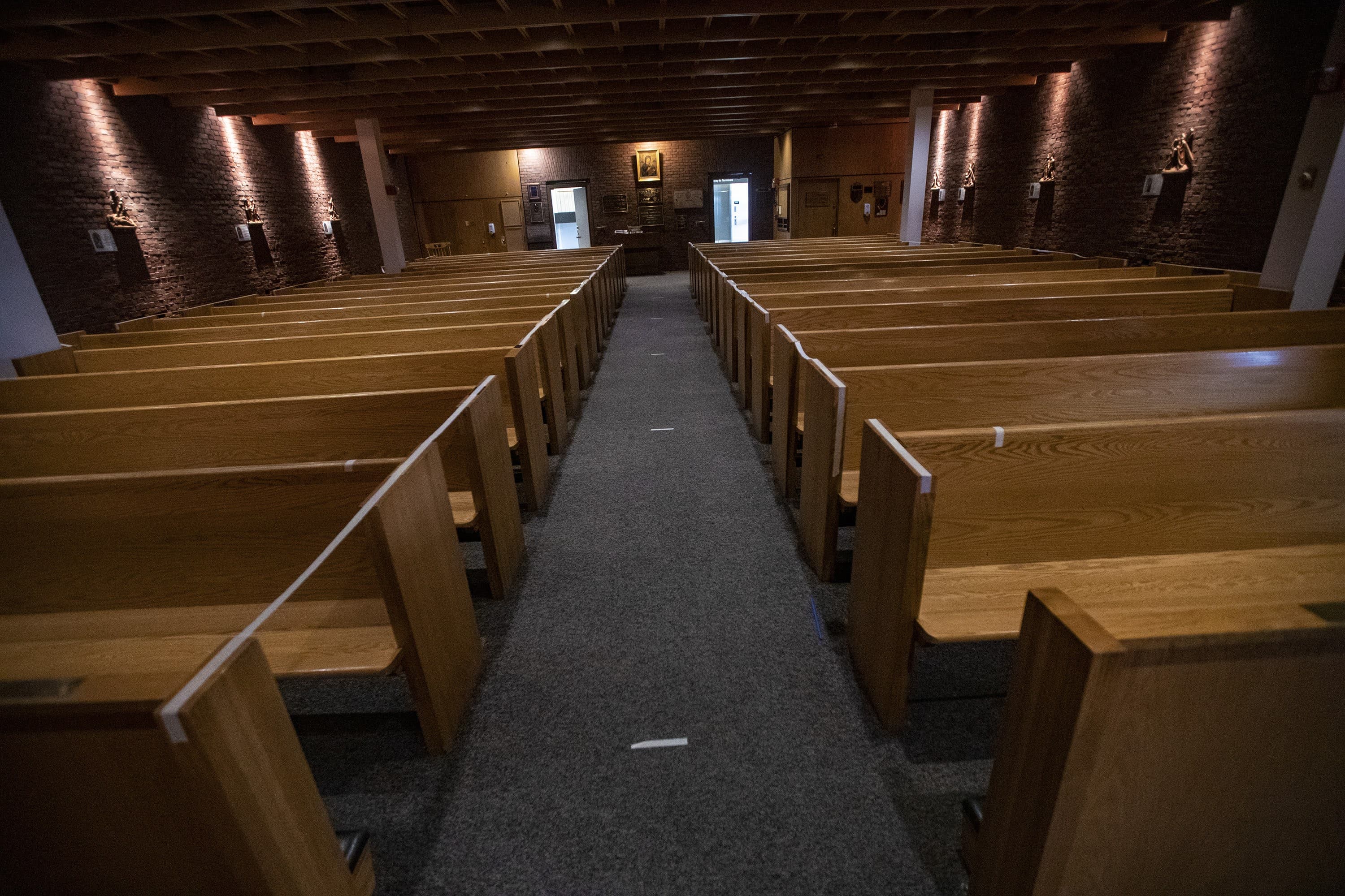 Pews are taped off, and the aisles have markings every 8 feet to ensure social distancing and reduce the spread of COVID-19 at the Our Lady of the Airways chapel at Logan Airport. (Jesse Costa/WBUR)