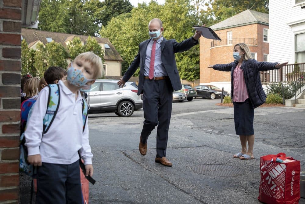 Principal Pat Boyden encourages students to social distance as they arrive at St. Peter School in the morning. (Robin Lubbock/WBUR)