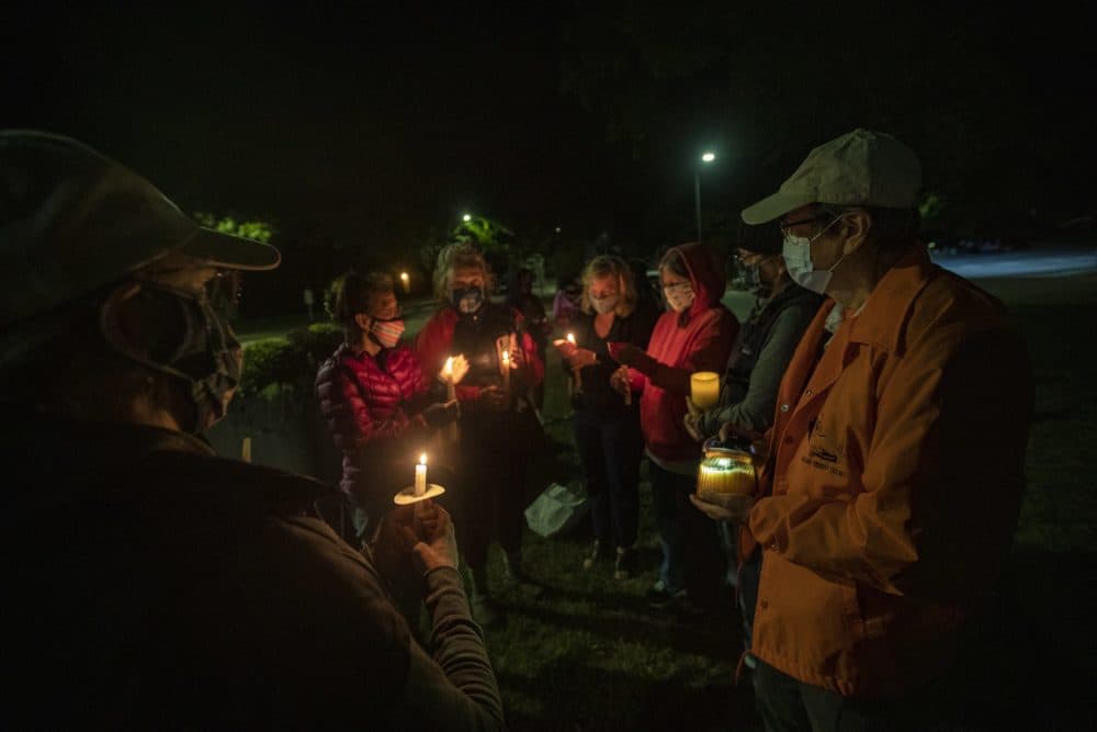 A small group of people gathered in Monument Square in Concord to pay respects to Ruth Bader Ginsburg shortly after the announcement of her death Friday evening. (Jesse Costa/WBUR)