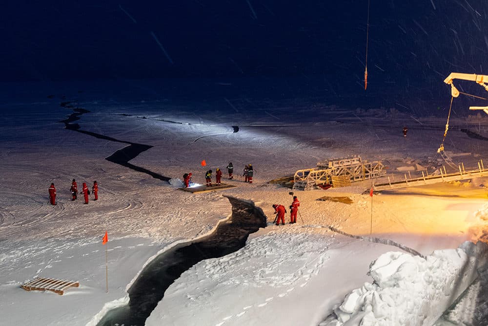 Sea ice opened up next to the vessel. This all happened during the night in the area where researchers parked their skidoos and stored some tools. At 2 a.m., the first officer on bridge watch woke up the crew and our logistics team to recover all equipment located on the sea ice next to the crack. One of the skidoos was already halfway in the water, but luckily they did not lose anything. The crew constructed a small wooden bridge above the crack. (Alfred-Wegener-Institut/Marcel Nicolaus)