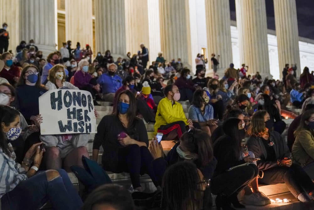 People gather at the Supreme Court Friday, Sept. 18, 2020, in Washington, after the Supreme Court announced that Supreme Court Justice Ruth Bader Ginsburg has died of metastatic pancreatic cancer at age 87. (Alex Brandon/AP)