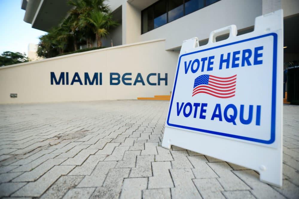 A sign directs voters to a polling location during the Florida presidential primary on March 17, 2020, in Miami Beach, Florida. (Cliff Hawkins/Getty Images)