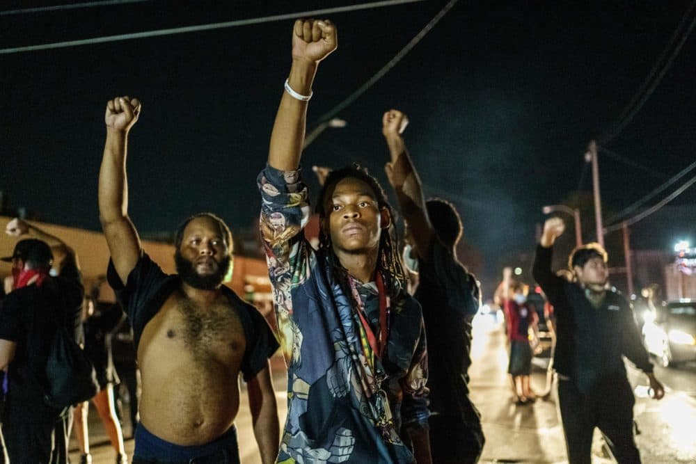Protesters raise their fists during a demonstration against the shooting of Jacob Blake in Kenosha, Wisconsin on August 26, 2020. (KEREM YUCEL/AFP via Getty Images)