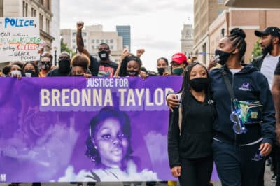 Activist Tamika Mallory marches with a child during a demonstration on September 23, 2020 in Louisville, Kentucky. Protesters marched in the streets in response to Attorney General Daniel Camerons handling of the Breonna Taylor case and the grand jury verdict indicting one of three officers involved in the killing of Breonna Taylor, who was fatally shot by Louisville Metro Police officers at her apartment on March 13, 2020 in Louisville, Kentucky. (Brandon Bell/Getty Images)