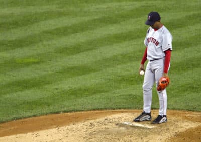 Pedro Martinez hangs his head after giving up a home run in the game that sent the New York Yankees to the 2003 World Series. (Doug Pensinger/Getty Images)