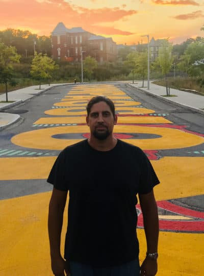 Artist Ricardo “Deme5” Gomez in front of his project "Rules of Engagement." (Courtesy Mushen Kieta)