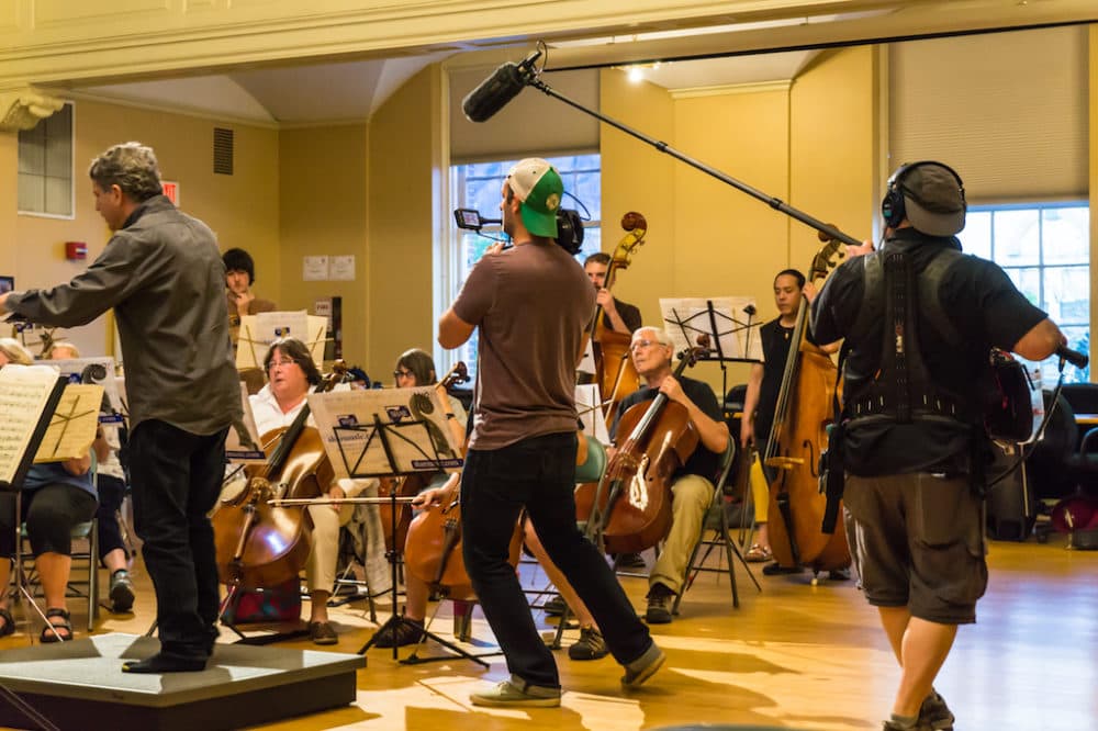 The documentary crew films the orchestra in rehearsal. (Courtesy)