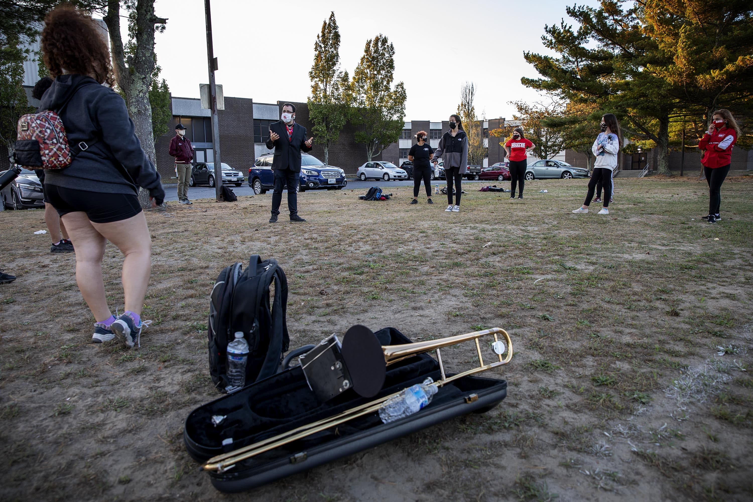 With the sun setting over the High School, Marching Band director Matt Pacheco winds up the practice. (Robin Lubbock/WBUR)