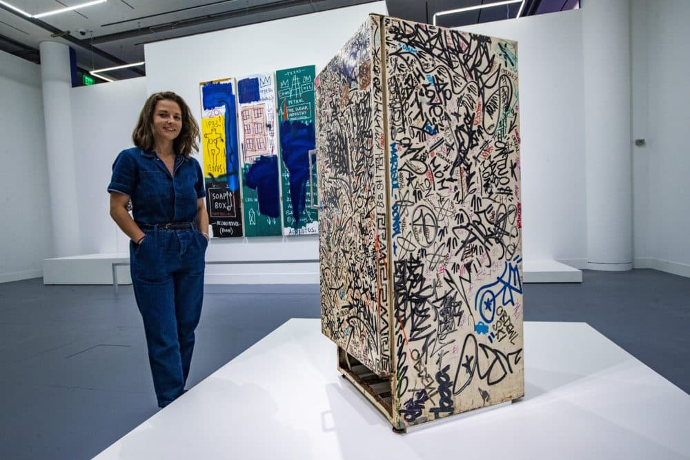 Liz Munsell, curator of contemporary art at the MFA, stands beside "Untitled (Fun Fridge)" by Jean‑Michel Basquiat. (Jesse Costa/WBUR)