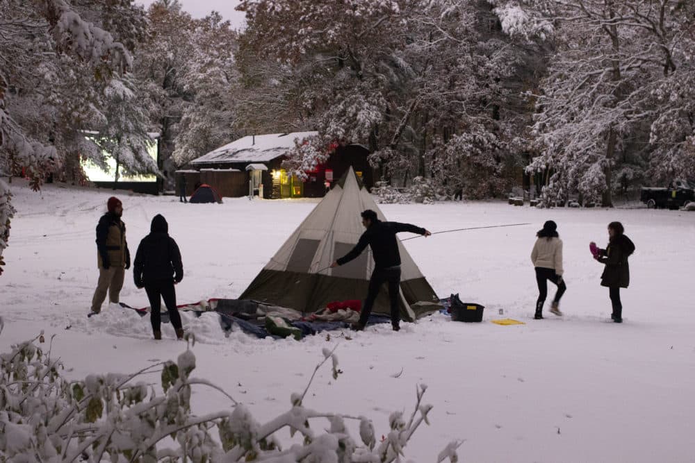 A group of die hard horror fans set up their tent and get ready to camp in the snow for the Coolidge Corner Theater’s “Cabin of Horror in the Rocky Woods” double feature. (Jenn Stanley/WBUR)