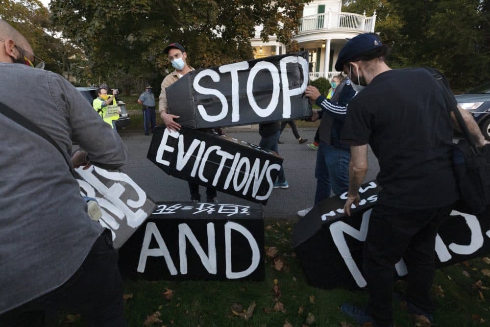 Housing activists erect a sign in front of Gov. Charlie Baker's house, Oct. 14, 2020, in Swampscott, Mass. (Michael Dwyer/AP)