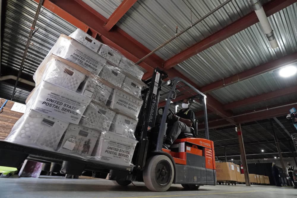 In this Sept. 3, 2020 photo, a forklift operator loads absentee ballots for mailing at the Wake County Board of Elections as preparations for the upcoming election are ongoing in Raleigh, N.C. U.S. Postal Service records show delivery delays have persisted across the country as millions of Americans began voting by mail. (Gerry Broome/AP File)