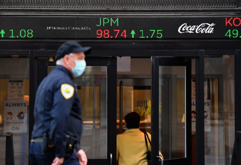 People walk by the New York Stock Exchange (NYSE) in lower Manhattan on Oct. 5, 2020 in New York City. (Angela Weiss/AFP via Getty Images)