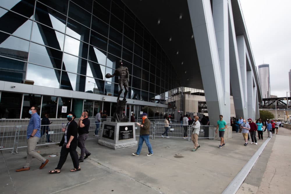 Voters line up outside of State Farm Arena, Georgia's largest early voting location, for the first day of early voting in the general election on October 12, 2020 in Atlanta, Georgia. (Jessica McGowan/Getty Images)